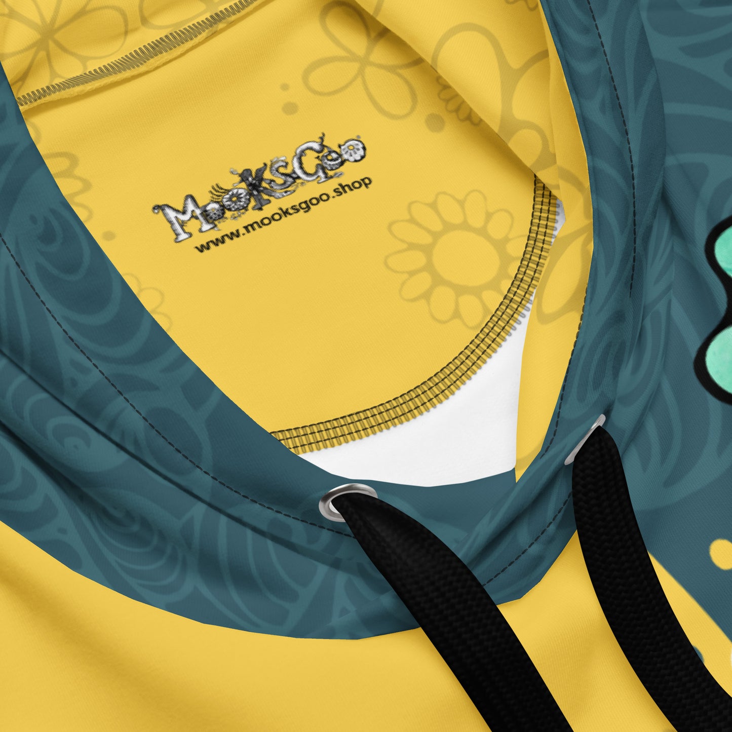 Close up of hood, metal grommets, and a thick black chord, with the MooksGoo logo on the inside panel