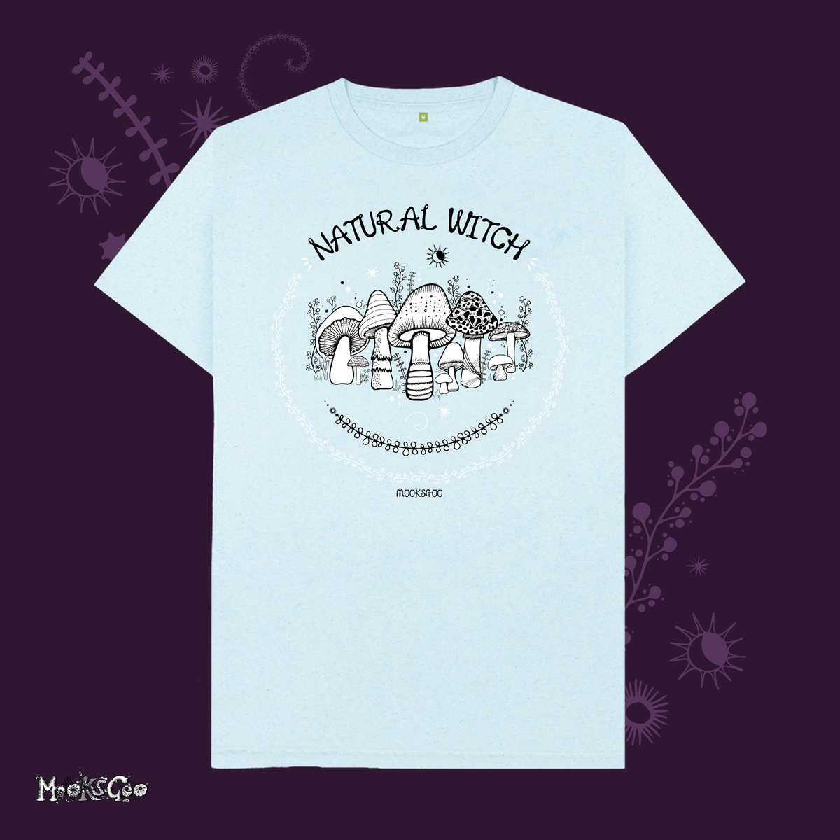 light blue organic cotton recycled t-shirt with script typography fonts that says natural witch, with black and white illustrations of mushrooms, toadstools, leaves, sun and moon and stars, designed by MooksGoo