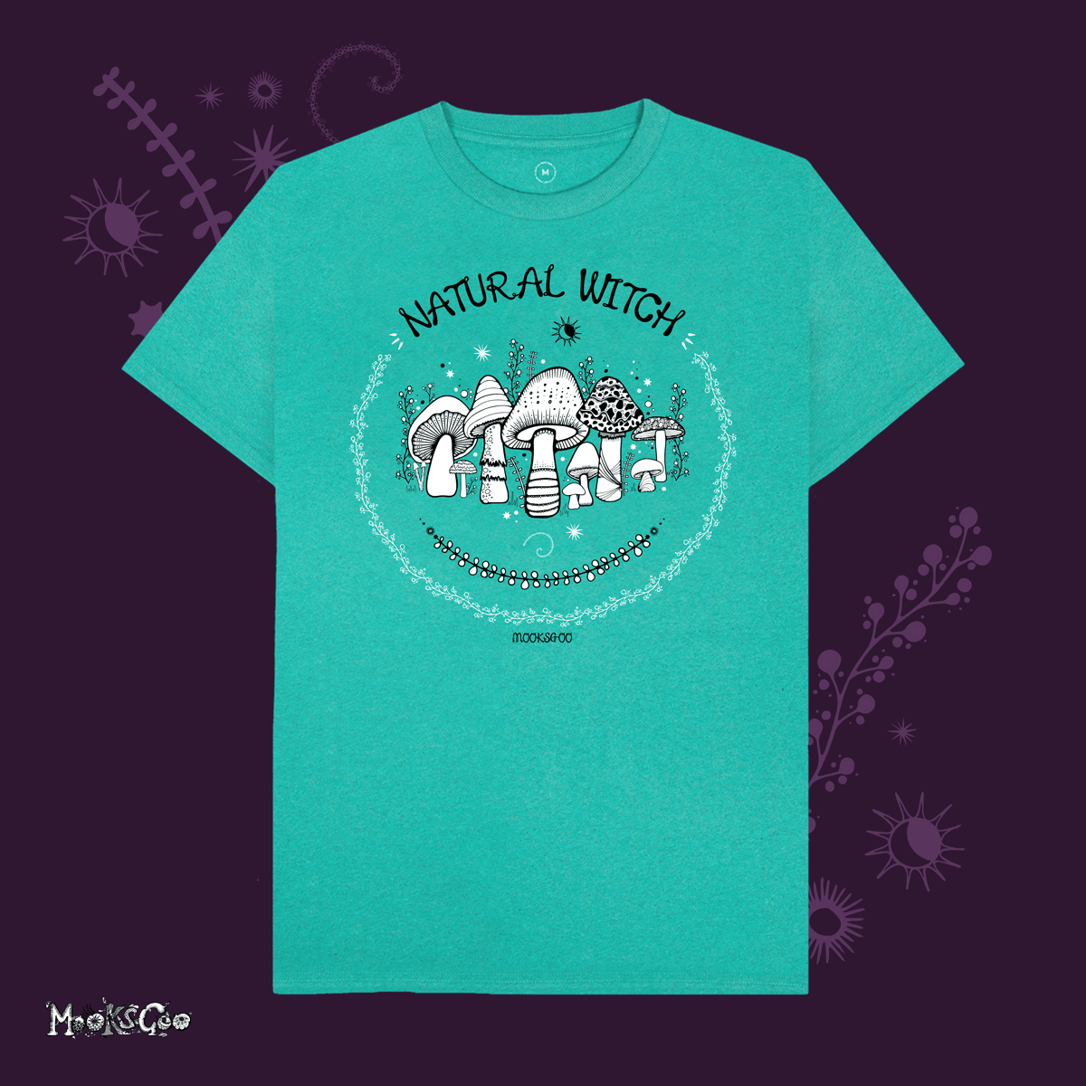 sea green organic cotton recycled t-shirt with script typography fonts that says natural witch, with black and white illustrations of mushrooms, toadstools, leaves, sun and moon and stars, designed by MooksGoo