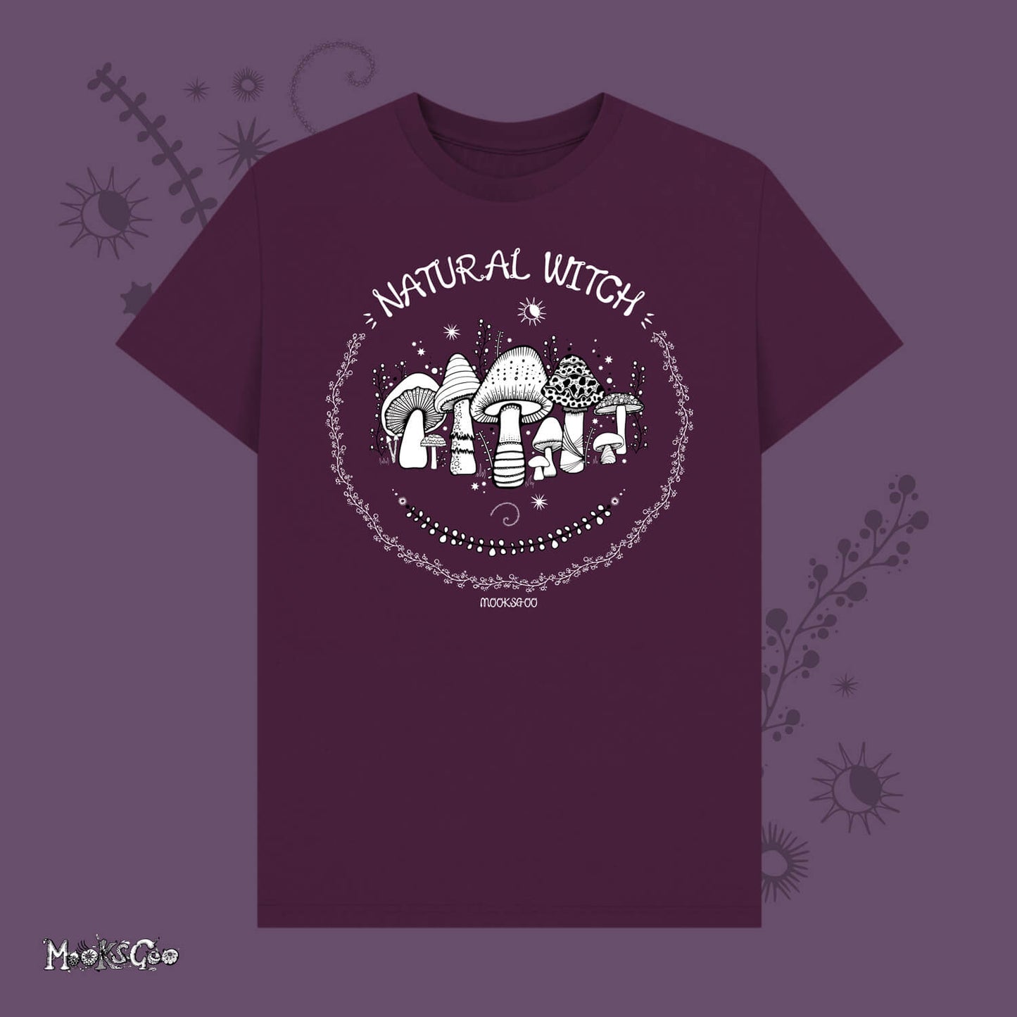Dark purple unisex t-shirt with white illustrations of mushrooms, toadstools, moons, stars, leaves and vines, with the words Natural Witch in funky typography, halloween spooky design by MooksGoo