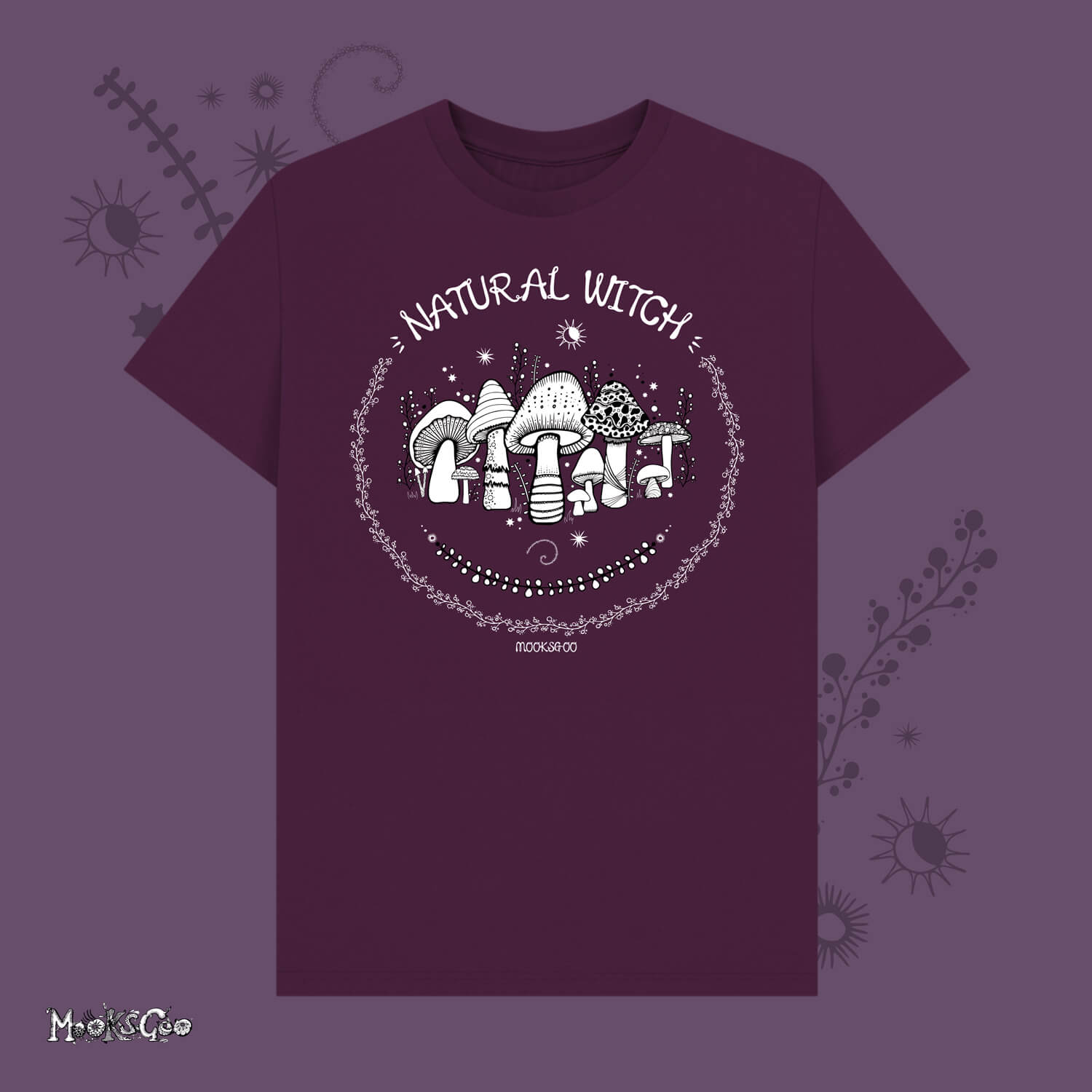 Dark purple unisex t-shirt with white illustrations of mushrooms, toadstools, moons, stars, leaves and vines, with the words Natural Witch in funky typography, halloween spooky design by MooksGoo