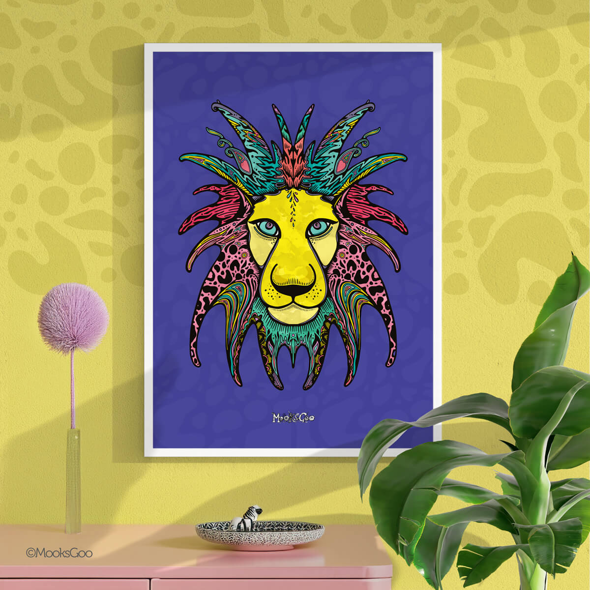 Bright mustard yellow wall with animal print details, a green plant and a pink sideboard unit, with the focal point being a wild lion wall art illustration, with purple, yellow, pink, turquoise and black colours. Original illustration design by MooksGoo