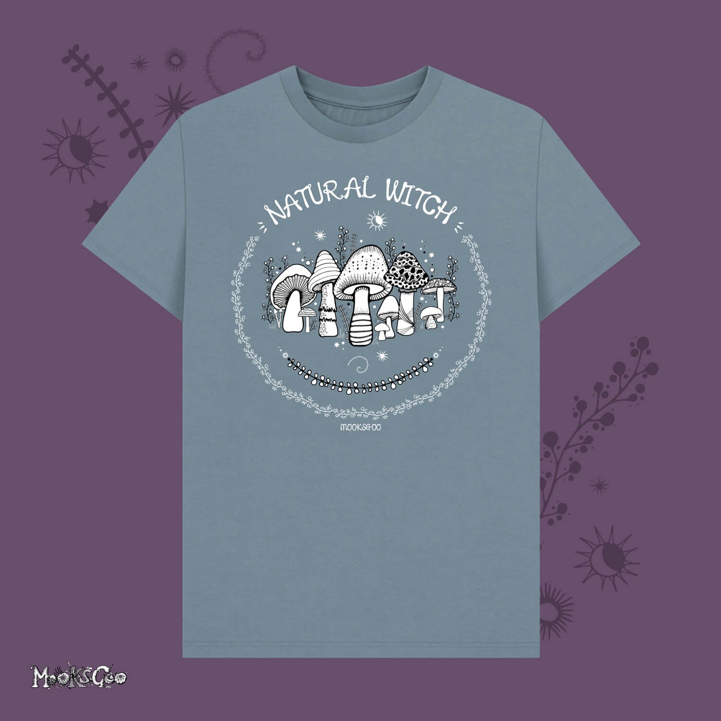 stone blue unisex t-shirt with white illustrations of mushrooms, toadstools, moons, stars, leaves and vines, with the words Natural Witch in funky typography, halloween spooky design by MooksGoo