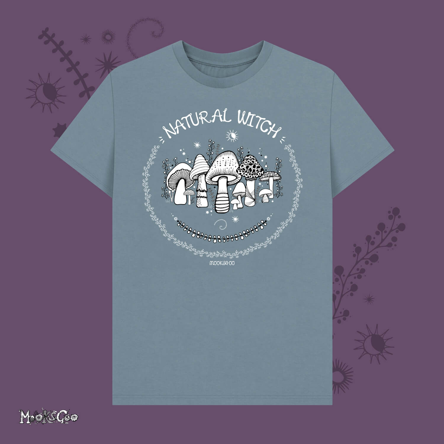 stone blue unisex t-shirt with white illustrations of mushrooms, toadstools, moons, stars, leaves and vines, with the words Natural Witch in funky typography, halloween spooky design by MooksGoo