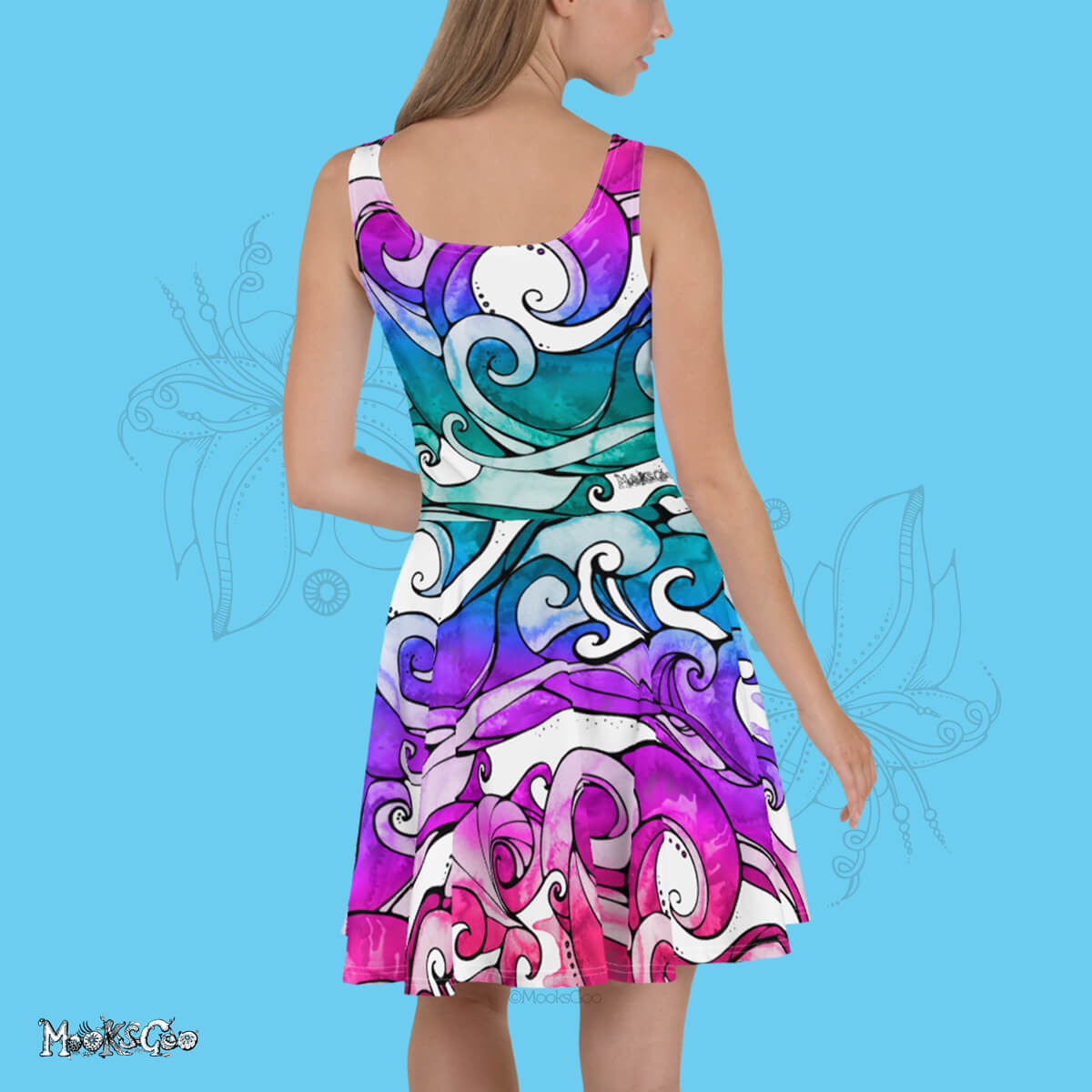 A female model facing backwards, wearing a MooksGoo original designer dress, with illustrated surfing waves with rainbow colouring