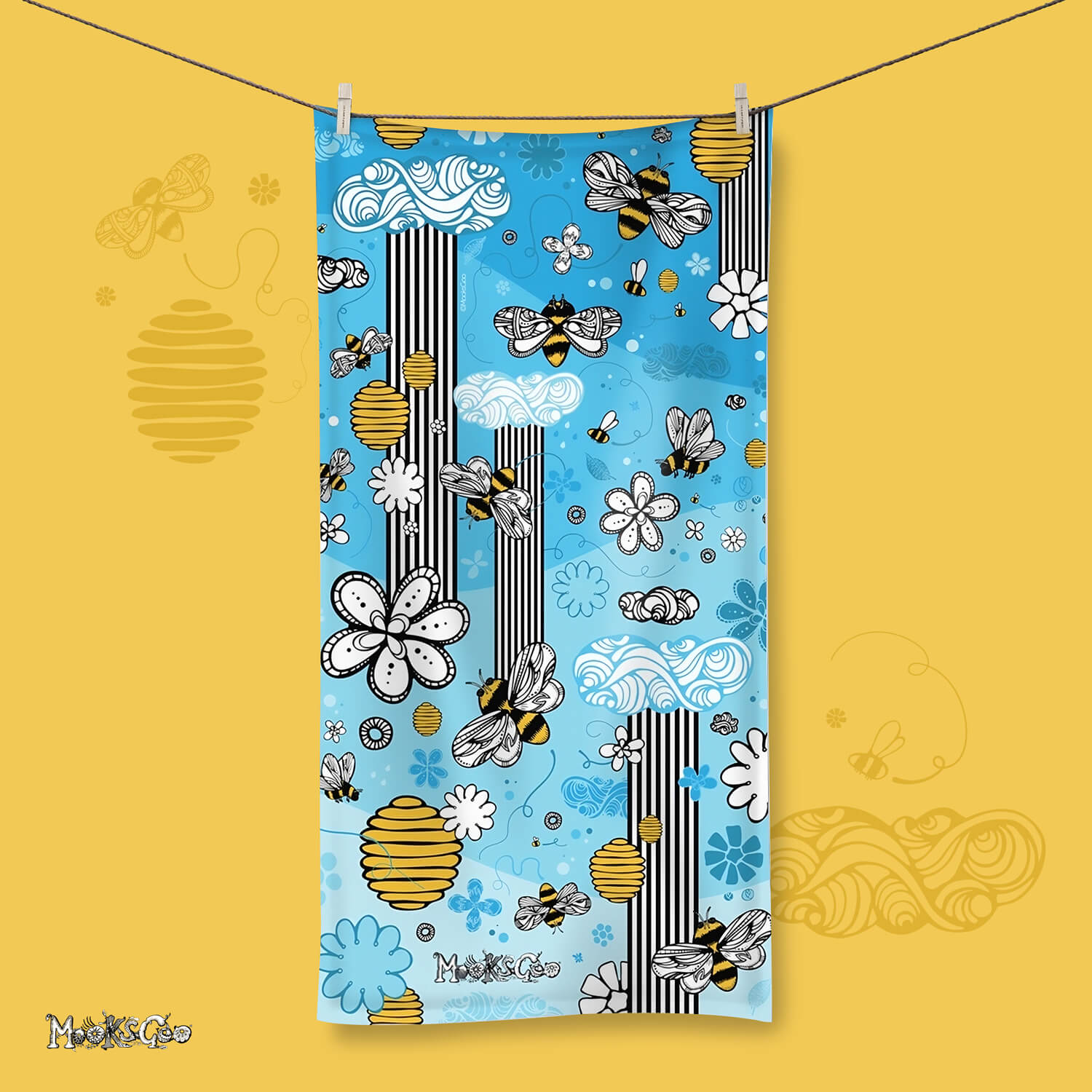a vibrant beach or bath towel with a sky blue background, adorned with hand illustrated honey bees, bees, honey, flowers, clouds and nature. Designed by MooksGoo
