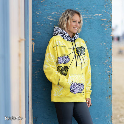 Fun sunshine themed hoodie, with a yellow, black and white design by MooksGoo. Model is Michelle Lott (MooksGoo) wearing a size L, pictured on Shanklin seafront on the Isle of Wight
