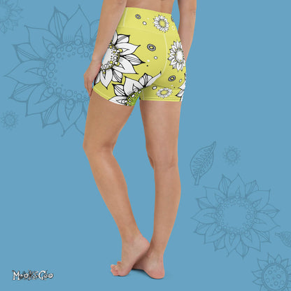Funky lime green comfortable, super buttery soft yoga, workout, or cycling shorts, with bold black and white sunflowers, designed by MooksGoo. Model showing the back of the shorts