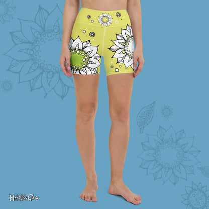 Funky lime green comfortable, super buttery soft yoga, workout, or cycling shorts, with bold black and white sunflowers, designed by MooksGoo. Model showing the front of the shorts