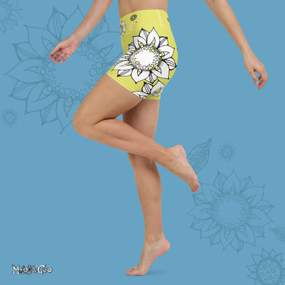 Funky lime green comfortable, super buttery soft yoga, workout, or cycling shorts, with bold black and white sunflowers, designed by MooksGoo. Model showing the left side of the shorts. 