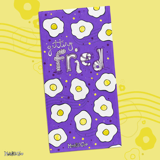 Getting Fried beach or bathroom towel with illustrated fried eggs, designed by MooksGoo